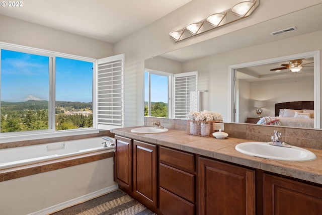 bathroom with visible vents, a sink, and a healthy amount of sunlight