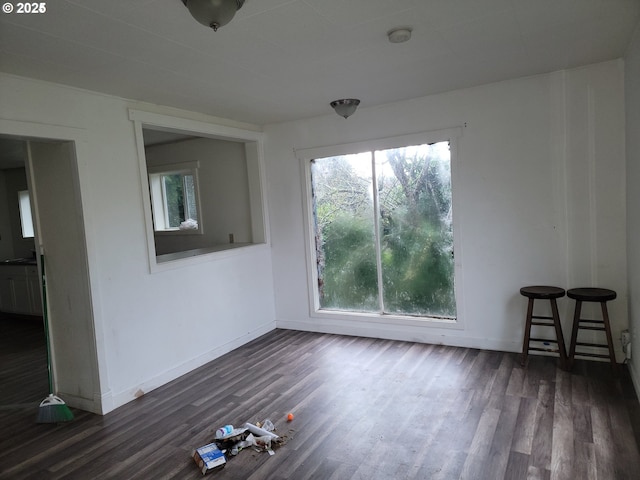 empty room with dark hardwood / wood-style floors