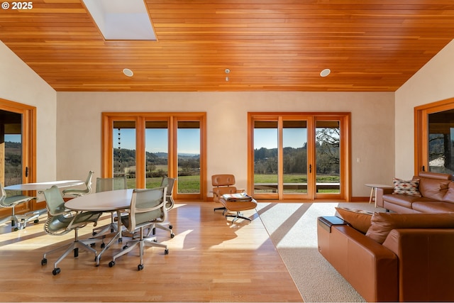 sunroom / solarium with vaulted ceiling, plenty of natural light, and wooden ceiling