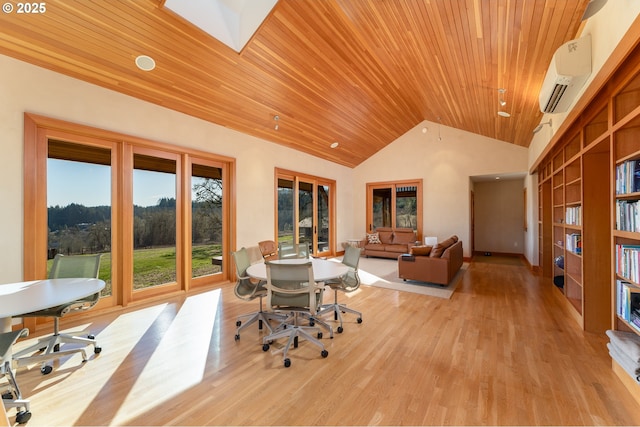 office featuring an AC wall unit, wooden ceiling, vaulted ceiling with skylight, and light hardwood / wood-style floors