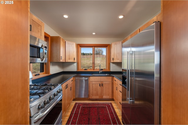 kitchen with sink, wood-type flooring, and appliances with stainless steel finishes