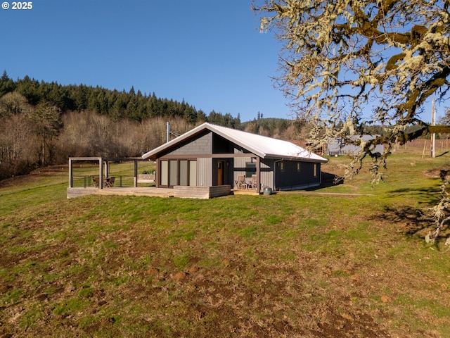 back of property featuring an outbuilding and a yard