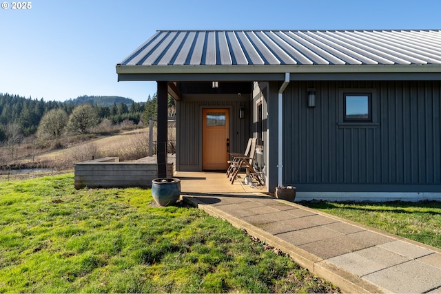 view of exterior entry with a yard