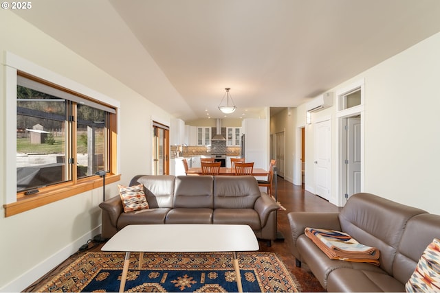 living room with an AC wall unit and dark hardwood / wood-style floors