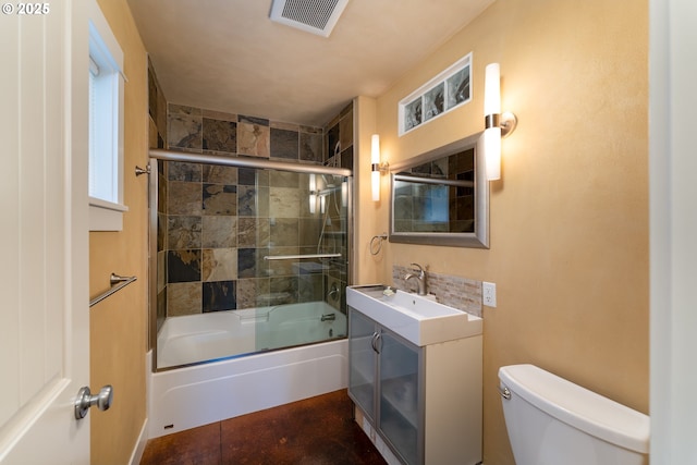 full bathroom featuring vanity, toilet, and combined bath / shower with glass door