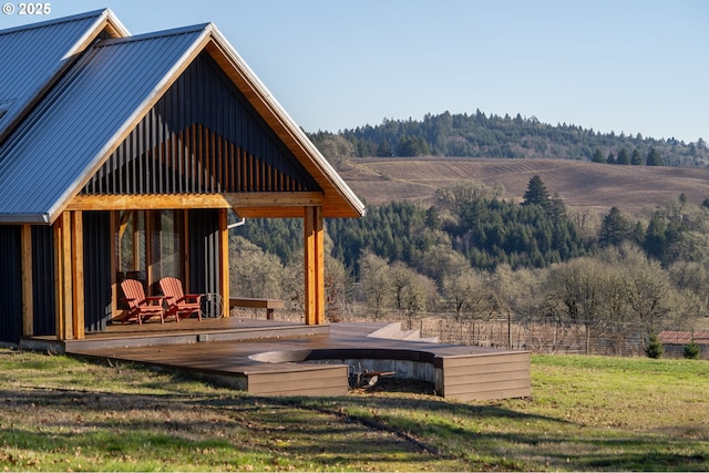 deck with a lawn and a rural view