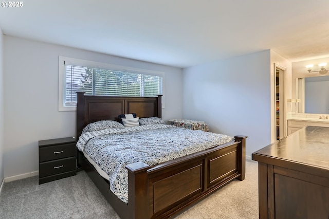 bedroom featuring baseboards and light carpet