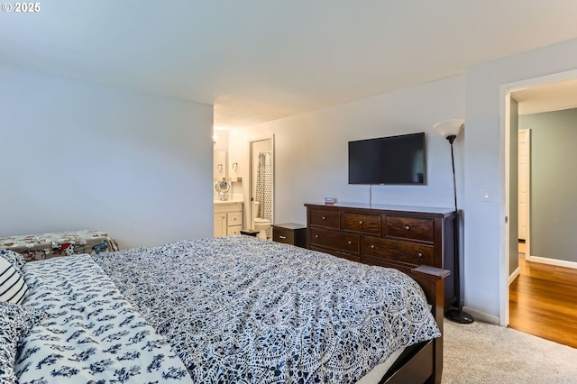 bedroom featuring baseboards and carpet