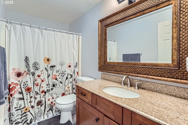 full bathroom featuring vanity and toilet