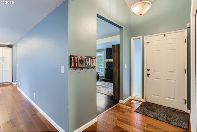 entrance foyer featuring visible vents, baseboards, and wood finished floors