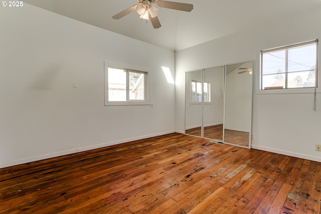 unfurnished bedroom featuring a closet, dark hardwood / wood-style floors, and ceiling fan