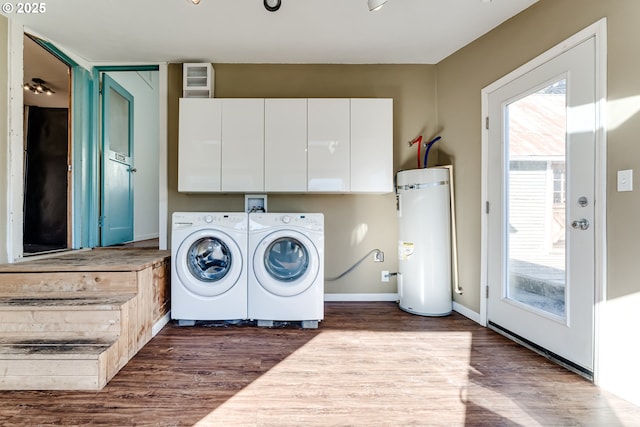 laundry room featuring water heater, a healthy amount of sunlight, dark hardwood / wood-style flooring, and independent washer and dryer