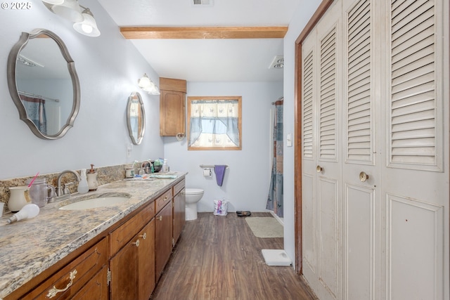 1453 N St, Springfield, OR 97477 - bathroom with a closet, wood finished floors, vanity, beam ceiling, and toilet