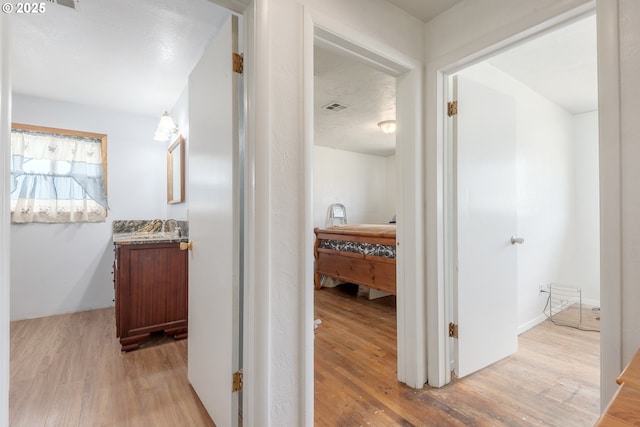 1453 N St, Springfield, OR 97477 - hallway featuring light wood-type flooring and a sink