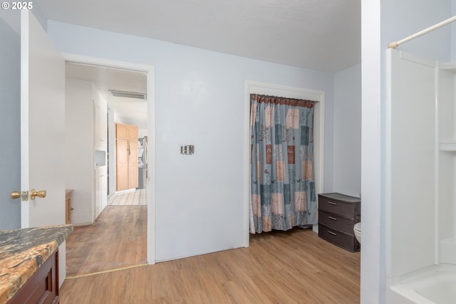 1453 N St, Springfield, OR 97477 - full bath with wood finished floors, toilet, curtained shower, and vanity