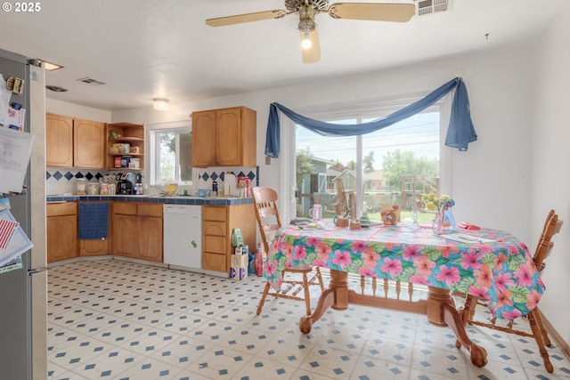 1453 N St, Springfield, OR 97477 - kitchen featuring white dishwasher, tile counters, open shelves, backsplash, and a ceiling fan