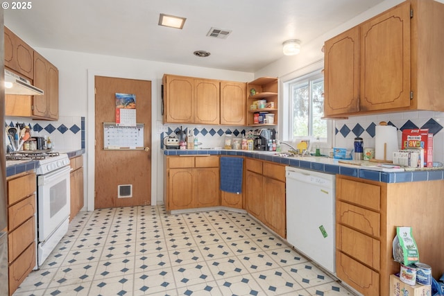 1453 N St, Springfield, OR 97477 - kitchen with white appliances, tile counters, under cabinet range hood, tasteful backsplash, and light flooring