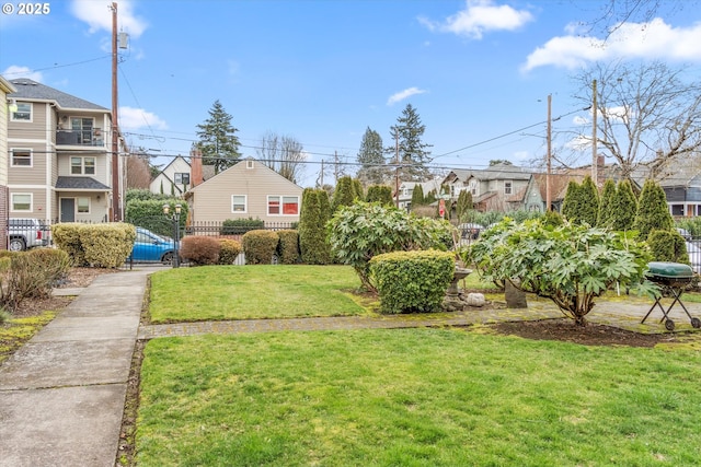 view of yard with fence and a residential view