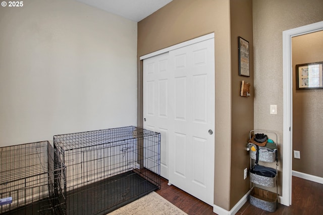 interior space with dark wood-style floors and baseboards