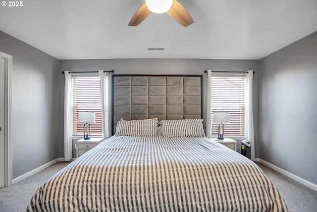 carpeted bedroom with multiple windows, visible vents, and baseboards