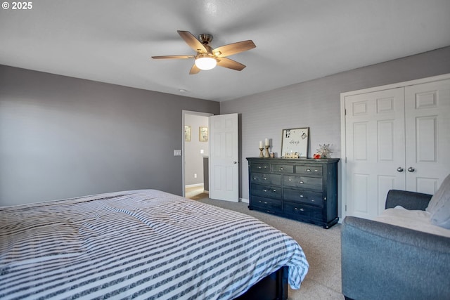 carpeted bedroom with a closet, baseboards, and a ceiling fan