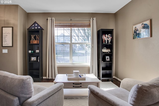 living area featuring wood finished floors and baseboards