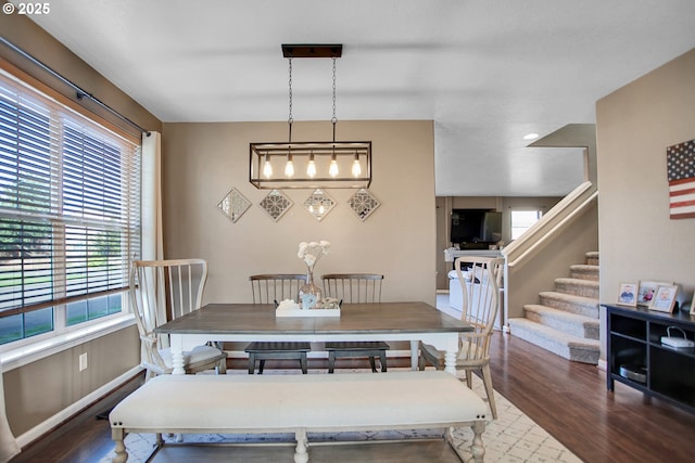 dining area featuring stairs and wood finished floors