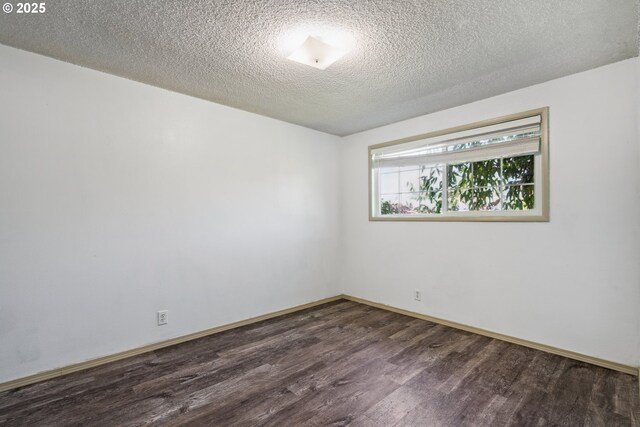 1885 N Danebo Ave, Eugene, OR 97402 - spare room with dark wood-style floors, baseboards, and a textured ceiling
