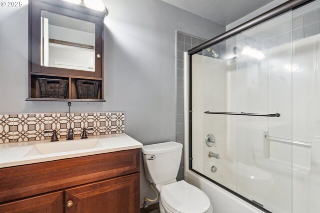 1885 N Danebo Ave, Eugene, OR 97402 - bathroom with decorative backsplash, toilet, vanity, and shower / bath combination with glass door