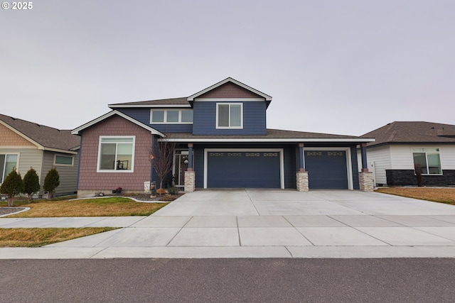 craftsman-style house featuring a garage and driveway