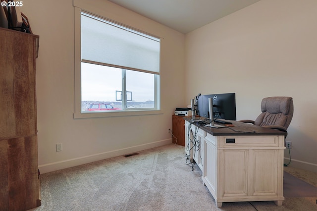 home office featuring visible vents, baseboards, and light colored carpet