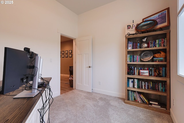 carpeted office space featuring baseboards