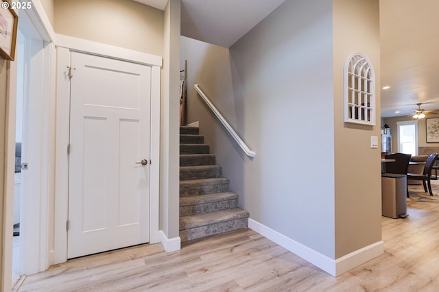 stairs featuring a ceiling fan, recessed lighting, wood finished floors, and baseboards