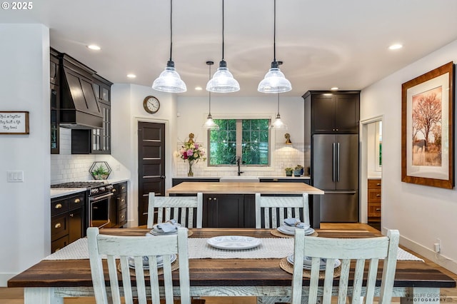 dining space featuring baseboards and recessed lighting