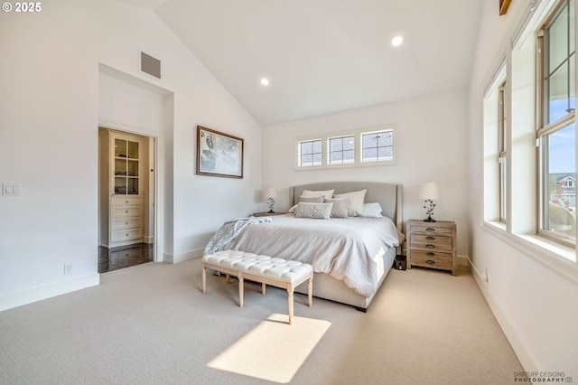carpeted bedroom featuring visible vents, recessed lighting, baseboards, and high vaulted ceiling