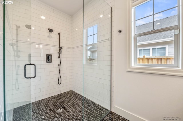 full bath featuring baseboards and a stall shower