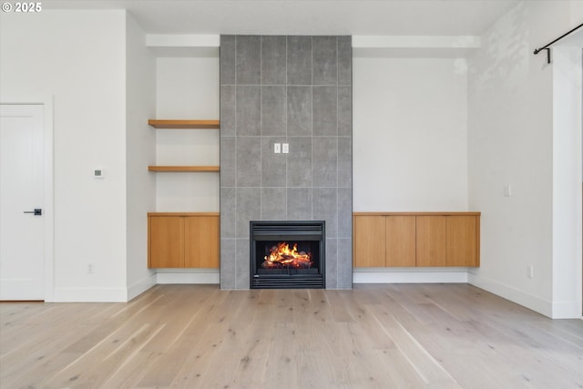 2585 SE 13th Ave, Portland, OR 97202 - unfurnished living room with a fireplace, light wood-type flooring, and baseboards