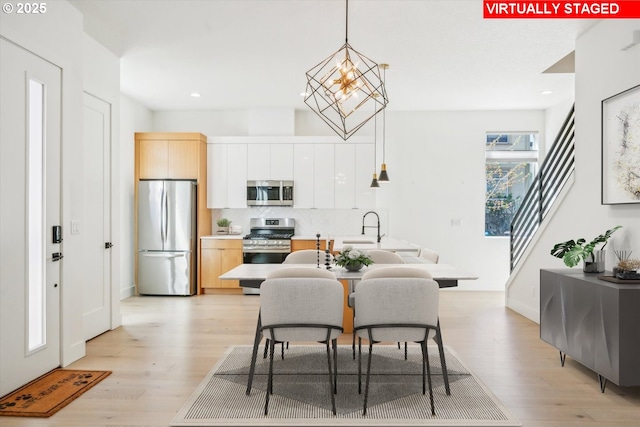 2585 SE 13th Ave, Portland, OR 97202 - dining area with light wood-type flooring, recessed lighting, and a chandelier