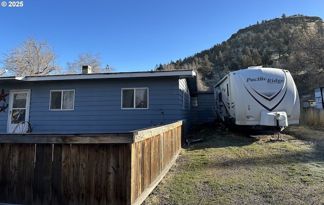 view of property exterior featuring a mountain view