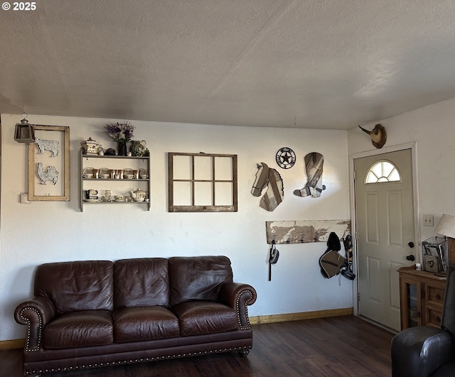 living room with dark hardwood / wood-style flooring and a textured ceiling