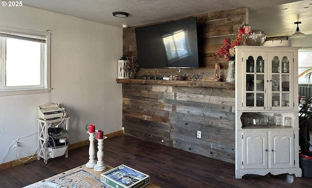 bar with white cabinetry, wooden walls, and dark wood-type flooring