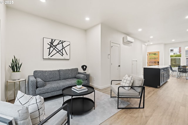 living room with light wood-type flooring and an AC wall unit