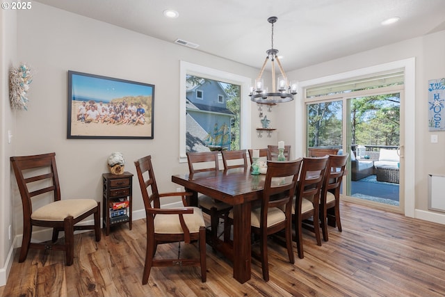 dining room featuring recessed lighting, visible vents, a notable chandelier, and wood finished floors