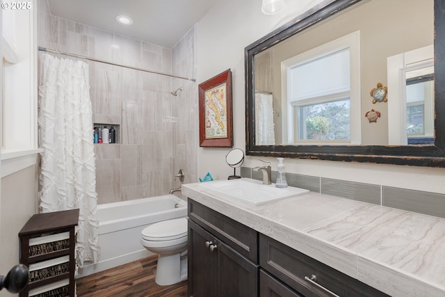 full bathroom featuring toilet, wood finished floors, shower / bath combination with curtain, vanity, and recessed lighting