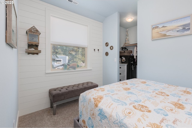 bedroom with visible vents and carpet flooring