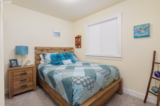 carpeted bedroom featuring baseboards