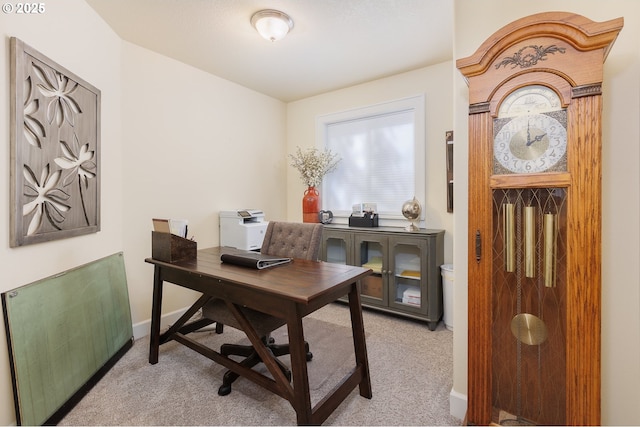 office space with light carpet, radiator, and baseboards