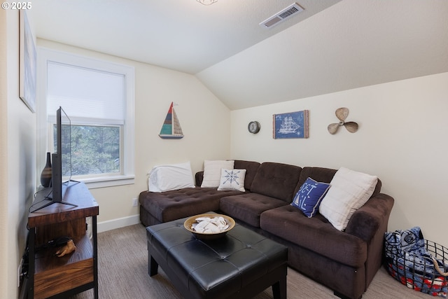 living area with visible vents, vaulted ceiling, and baseboards