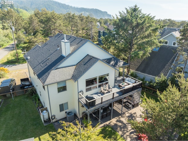 birds eye view of property featuring a view of trees