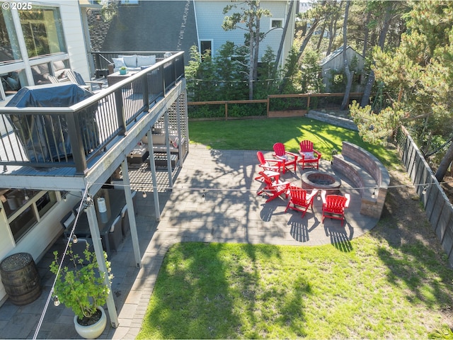 view of yard with a patio area, a fenced backyard, a fire pit, and a wooden deck